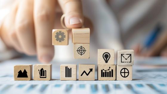 Company strategy icons on wooden blocks